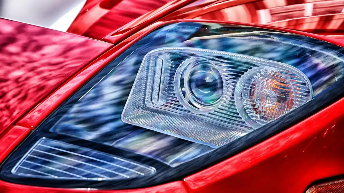 A clear, close-up view of a car headlight lens before restoration