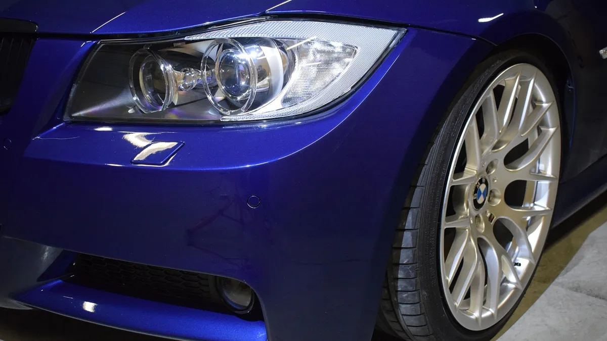 Close-up of a car headlight being professionally polished to remove oxidation