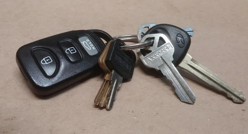 Close-up of a car key inserted into the ignition cylinder, where the transponder antenna reads the chip