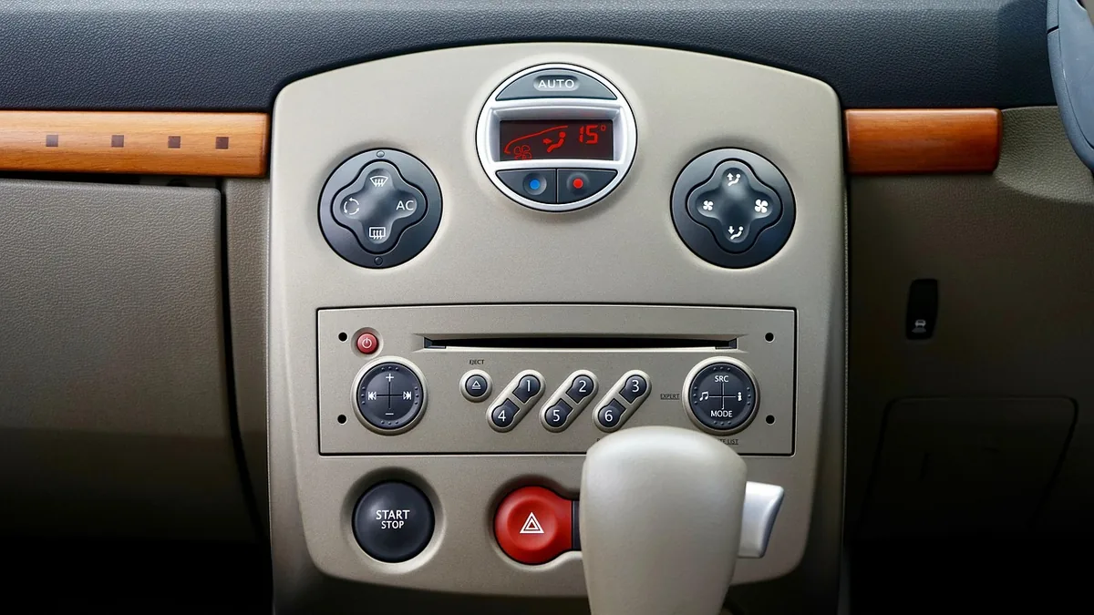 Car stereo menu and dial controls Car stereo control panel with menu, mode, and volume dial buttons used to access clock settings