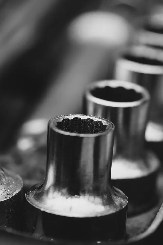 Black and white close-up of socket wrenches in a tool set