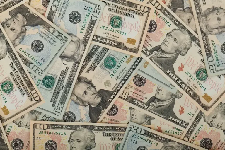 A scattered pile of US dollar bills