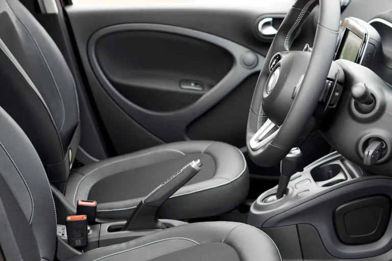 Dark front car seats with contrast stitching, ready for cleaning