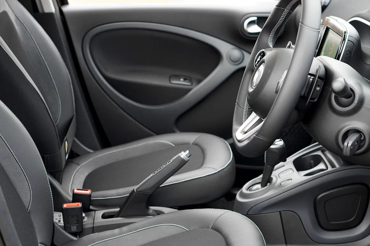 Dark front car seats with contrast stitching, ready for cleaning
