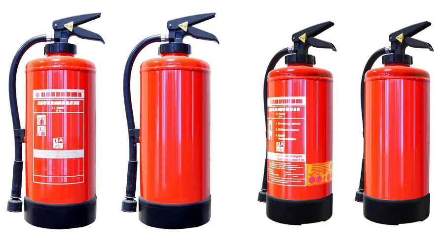 Four red fire extinguishers with black handles and hoses against a white background