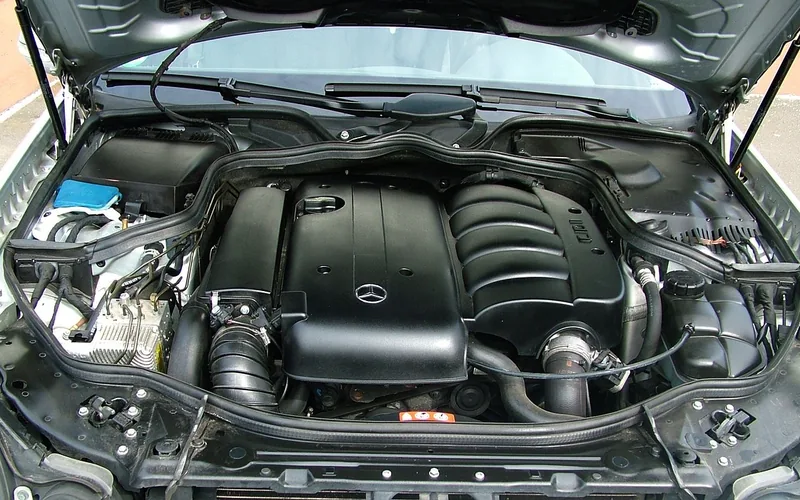 Open engine bay showing the coolant reservoir before adding coolant