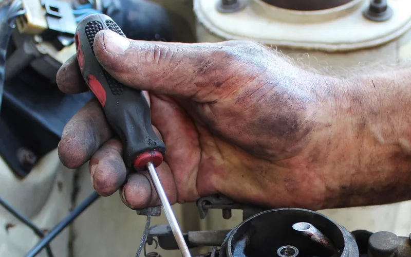 Twisting open a car coolant reservoir cap with a cloth for grip