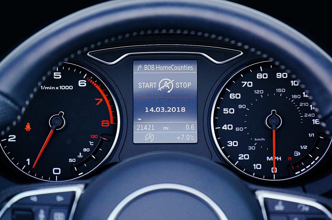 Car dashboard gauge cluster showing temperature reading