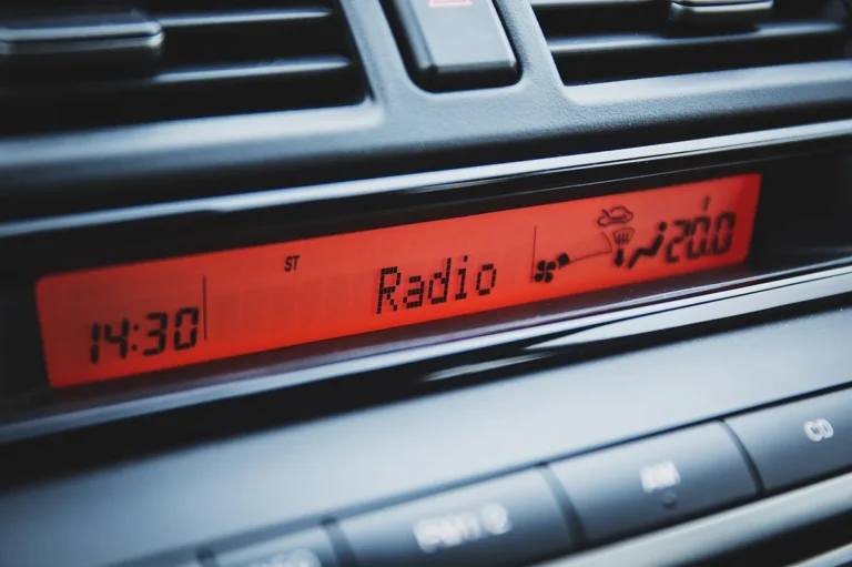 JVC car stereo display showing the clock set to 14:30 after adjusting the time