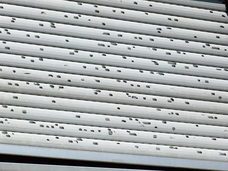 Metal roller shutter pitted by hail damage