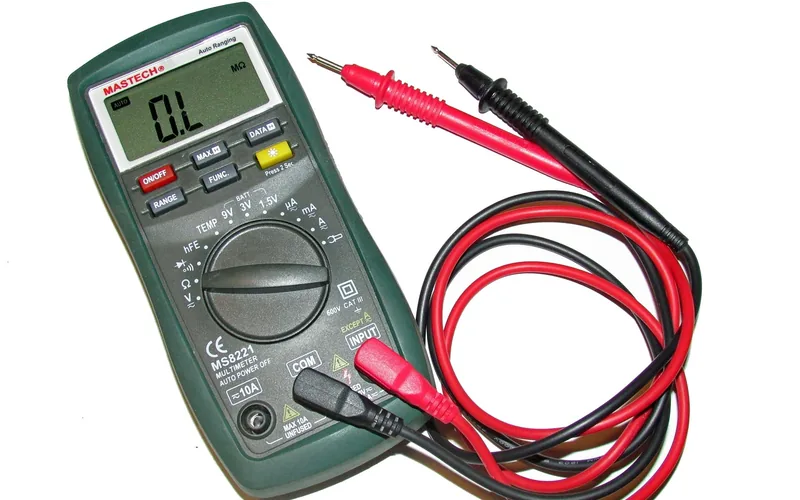 technician holding a digital multimeter used to test automotive electrical continuity technician holding a digital multimeter used to test automotive electrical continuity