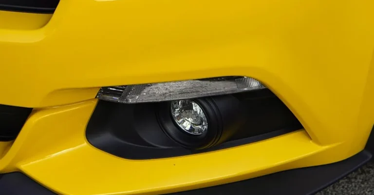Painted front bumper fascia corner with a fog light opening