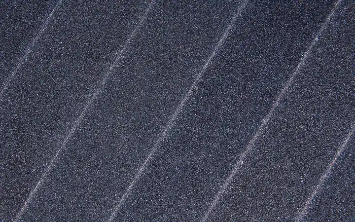Close-up of the gritty surface of a sheet of sandpaper
