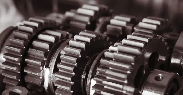 Close-up of meshed steel transmission gears on parallel shafts