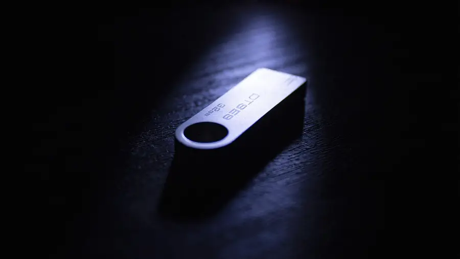 USB flash drive lying on a dark surface