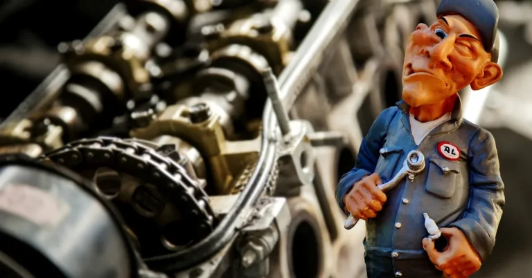 Mechanic using a wrench near a car engine bay to disconnect the battery terminal