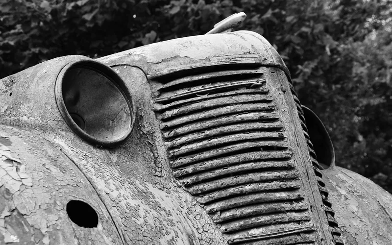 Rust forming on an engine hood where paint has failed and exposed bare metal