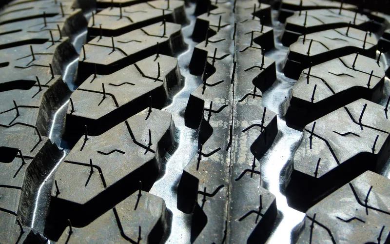 Close-up of a car tire tread pattern used to check wear and remaining traction Close-up of a car tire tread pattern used to check wear and remaining traction