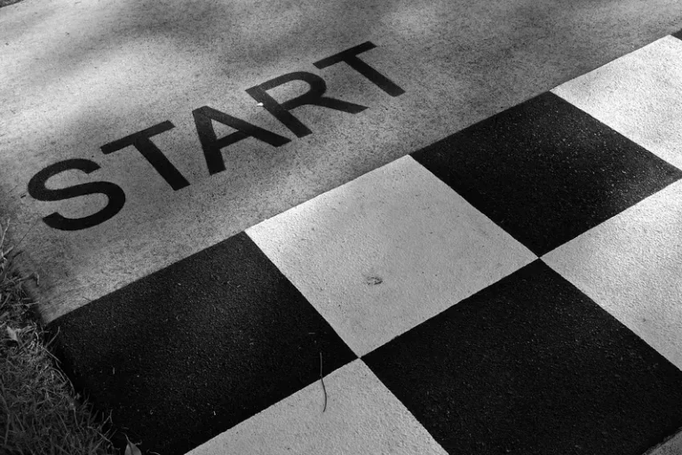 START and a black and white checkered pattern painted on pavement
