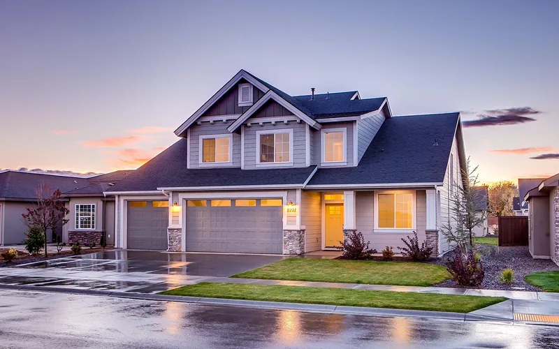Detached single-car garage next to a house driveway, the fully enclosed alternative to a carport