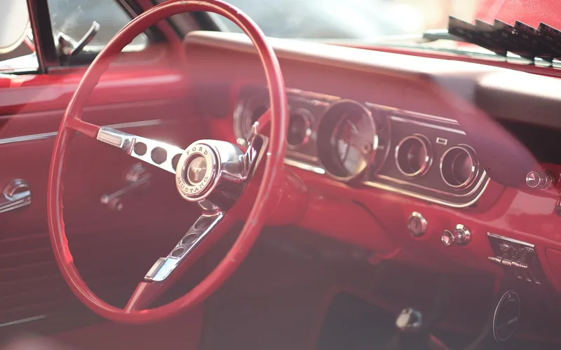 car dashboard fuel gauge showing the needle near empty