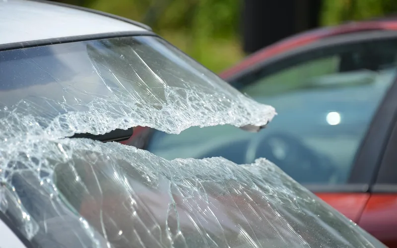 Windshield with severe shattered damage along its edge Windshield with severe shattered damage along its edge