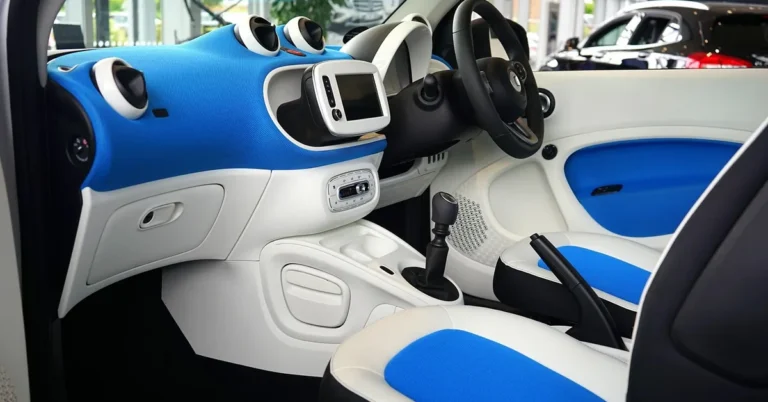 Interior of a small hatchback showing the dashboard, infotainment screen and steering wheel