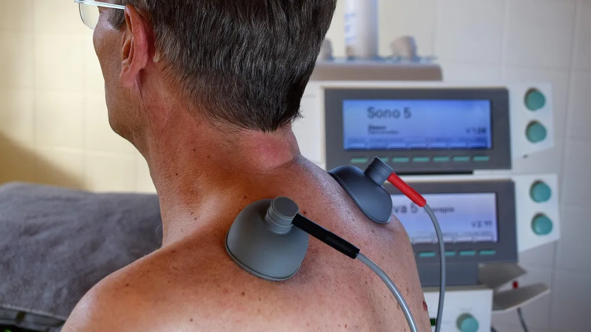 A physical therapist treating a patient's neck and shoulder pain, a common approach for whiplash and soft tissue injuries