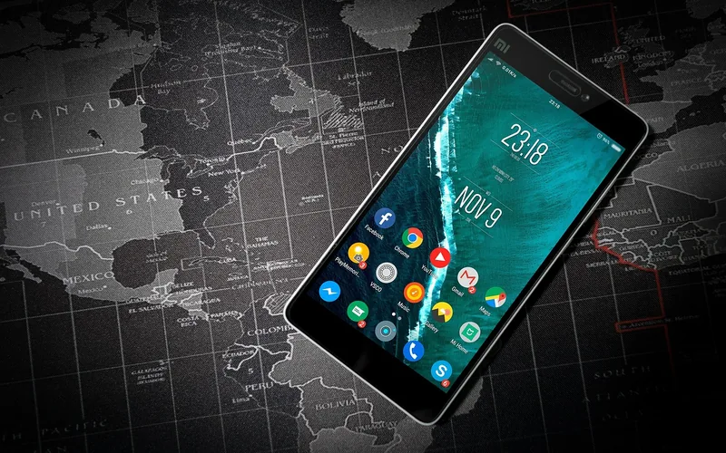 Android smartphone home screen lying on a map Android smartphone home screen lying on a map