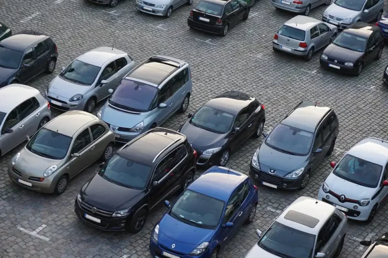 Rows of parked cars seen from above on a paved lot