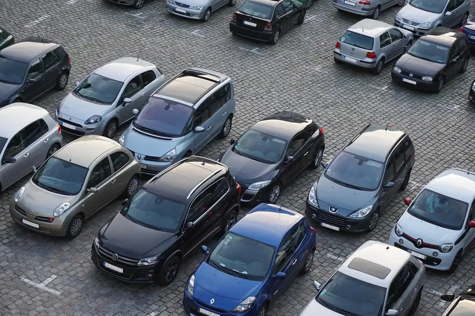 Rows of parked cars seen from above on a paved lot