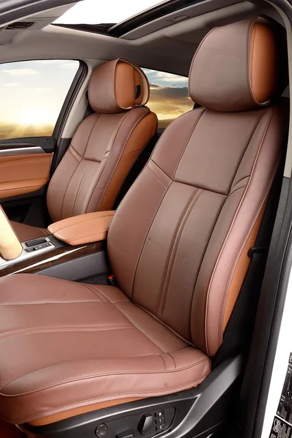 Brown perforated leather front seat inside a car
