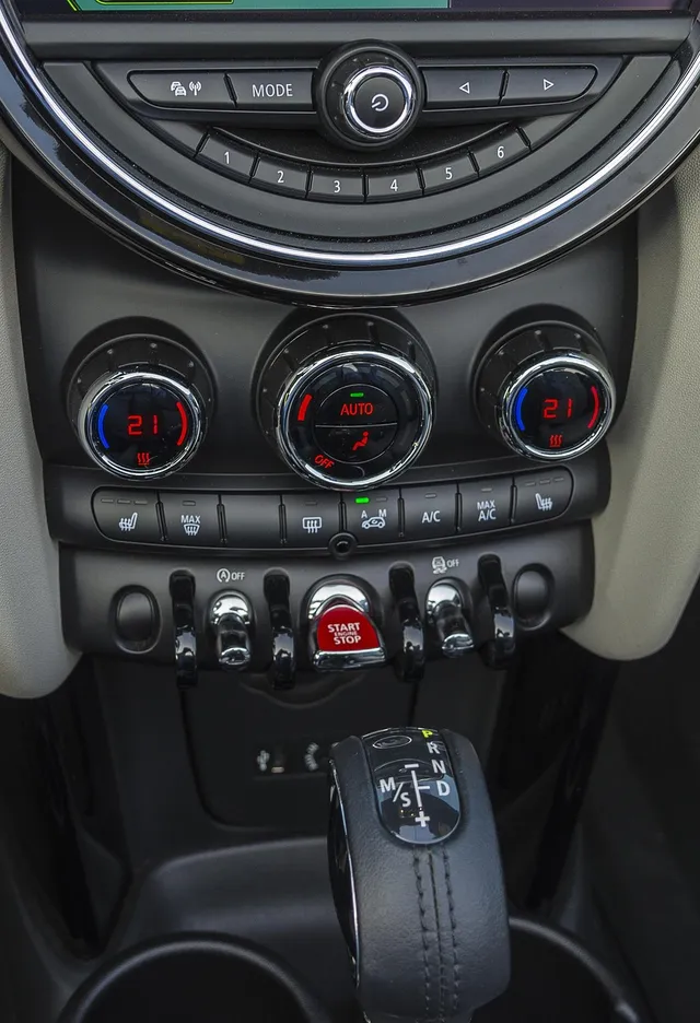 Climate control dials and A/C buttons on a car center console