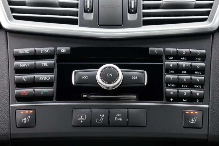 Car center console showing radio and CD control buttons and a knob below the air vents