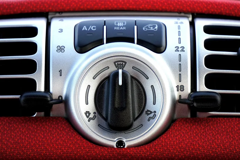 Car climate control panel with the A/C button, fan and temperature dial