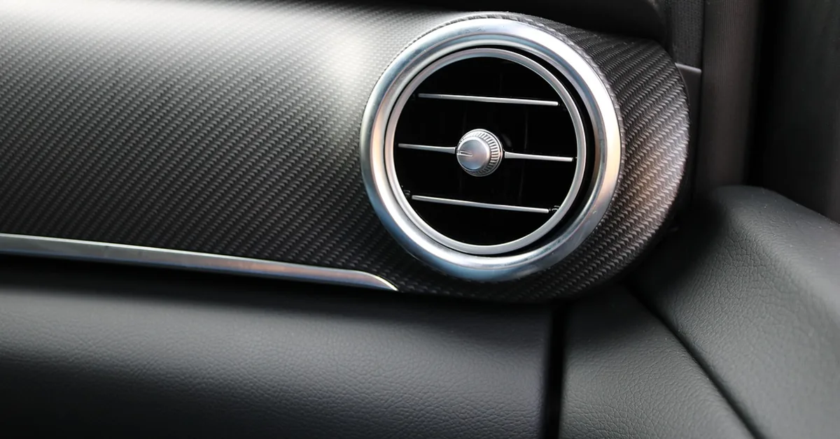 Round dashboard air vent in a car interior