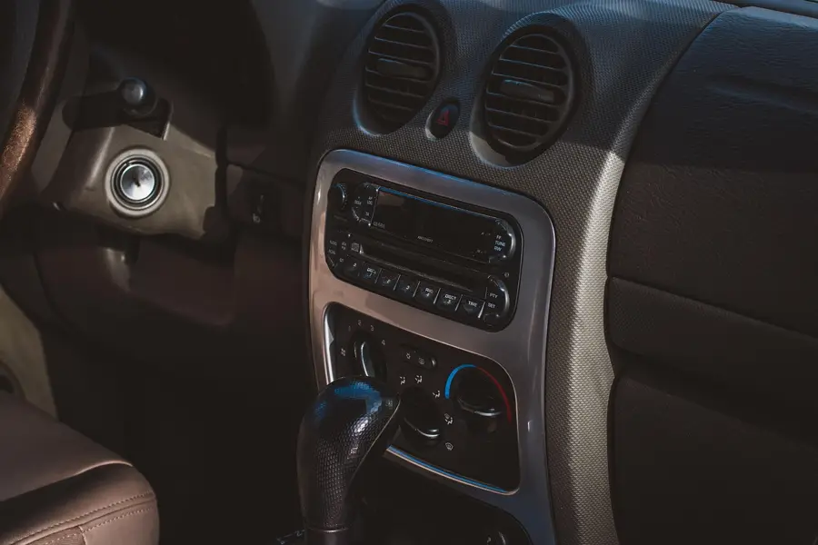 Older factory-style car radio and climate controls on a dashboard