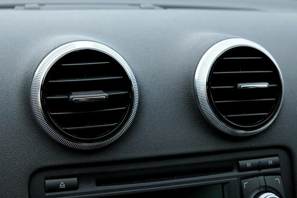Round dashboard air vents of a car with the AC running