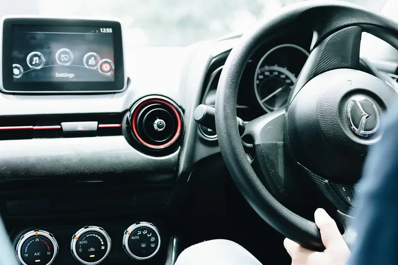 Car touchscreen head unit showing a Settings screen on the dashboard