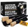Three boar hair car detailing brushes with a black storage bag
