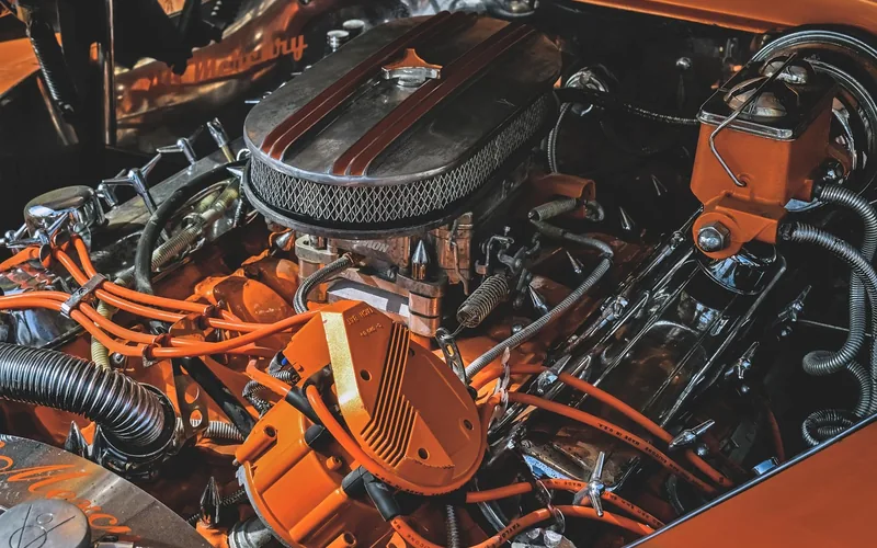 Engine bay with an air cleaner housing, rubber hoses and wiring