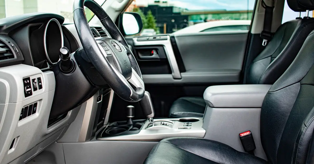 Clean SUV interior showing dashboard, door panel, and leather seats free of scuff marks