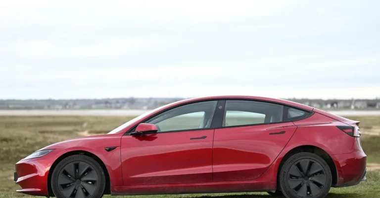 A modern four-door sedan viewed from the side, the vehicle type Uber requires for passenger rides