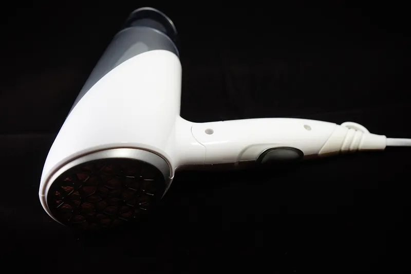 White hair dryer used to warm decal adhesive before peeling