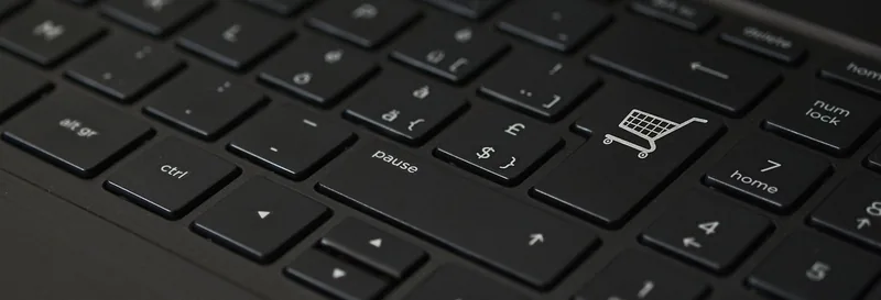 Laptop keyboard with a shopping cart icon on one key