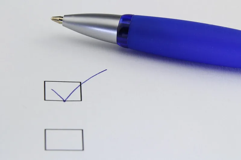 Pen next to a checklist box with one box ticked