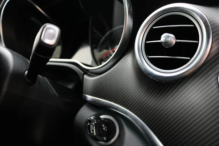 Round chrome-ringed air vent on a car dashboard