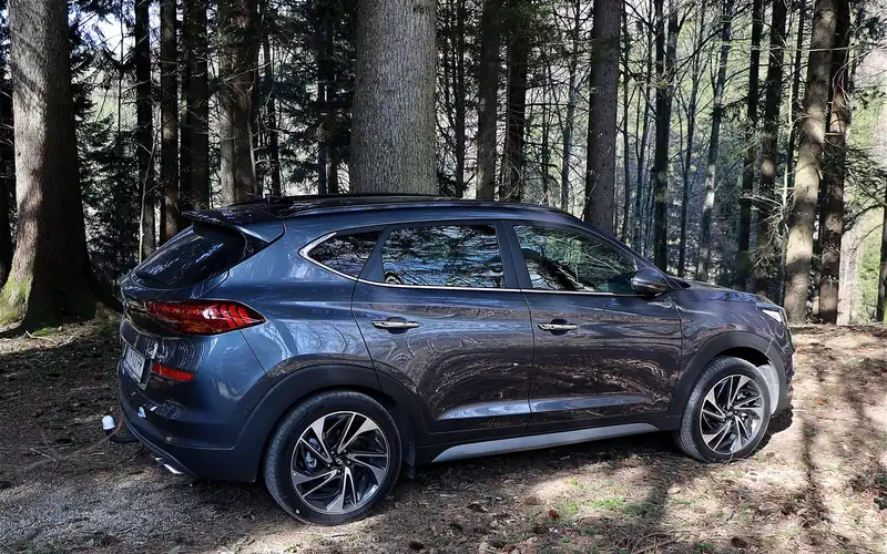 Gray SUV with black plastic fender cladding wrapped around its wheel arches Gray SUV with black plastic fender cladding wrapped around its wheel arches