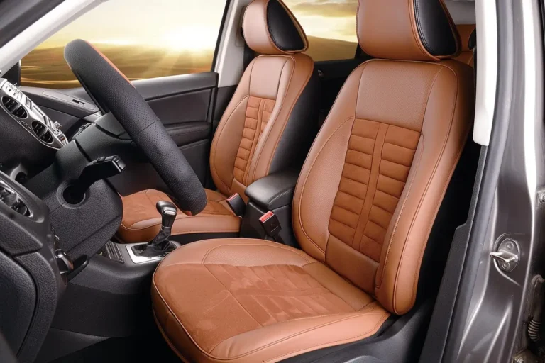 Tan leather front car seats with stitched bolsters inside a car