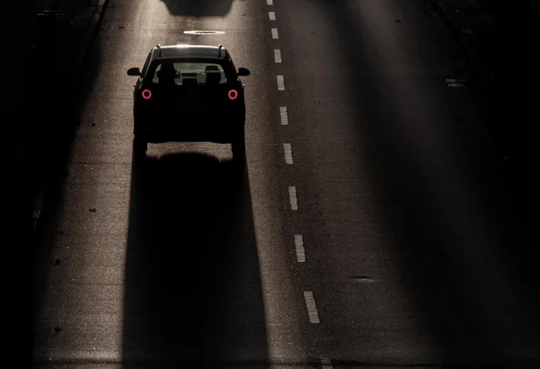 Car driving along a road in low evening light